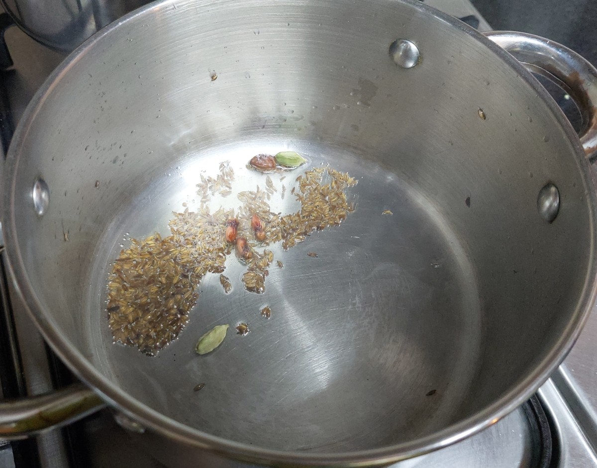 In a pan heat 1 tablespoon of oil, splutter 1 teaspoon of cumin seeds, add 1-2 star anise, 1-2 cloves and 1-2 cardamom. Fry for a few seconds.