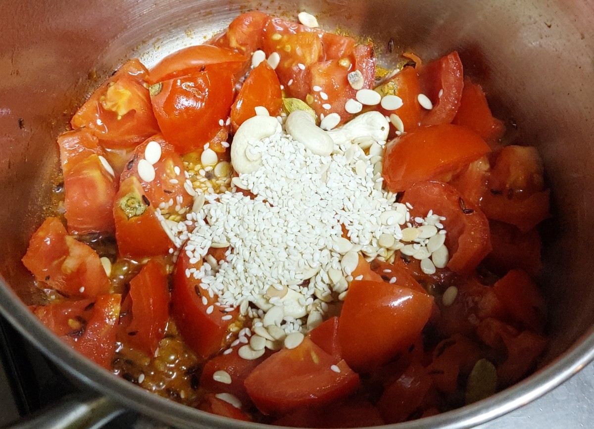 Add 1 teaspoon of sesame seeds, 1 teaspoon of melon seeds and 4-5 cashews. Mix well and fry till tomatoes turn mushy. Switch off the flame and let the mixture cool down.