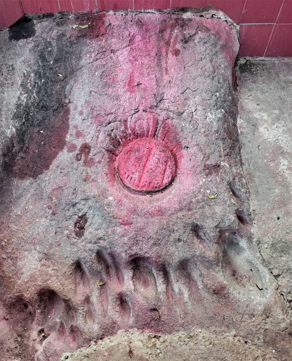 Foot prints of Goddess Durga with her tiger's scratch marks on stone; viewed from another angle
