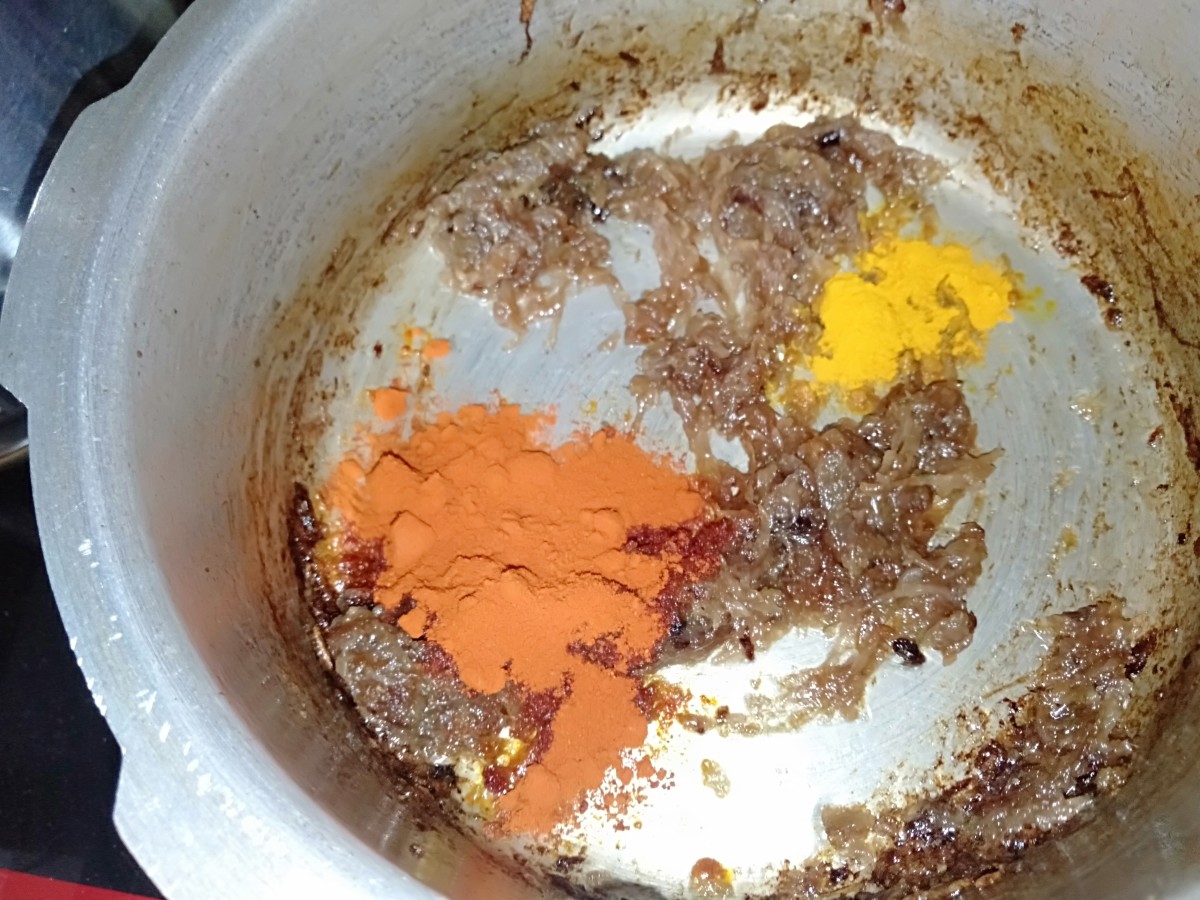 Add turmeric powder, salt, and red chilli powder over low flame.