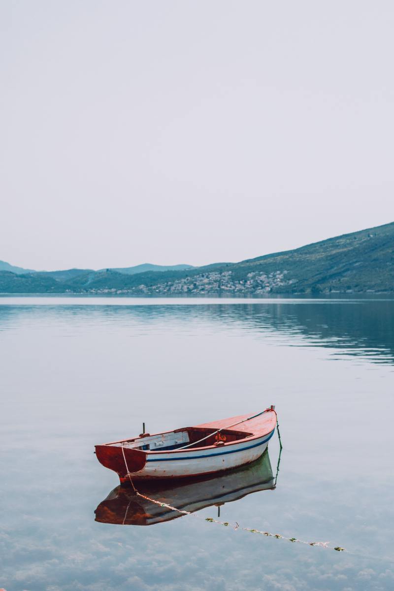 Small moored boat on peaceful lake in highlands