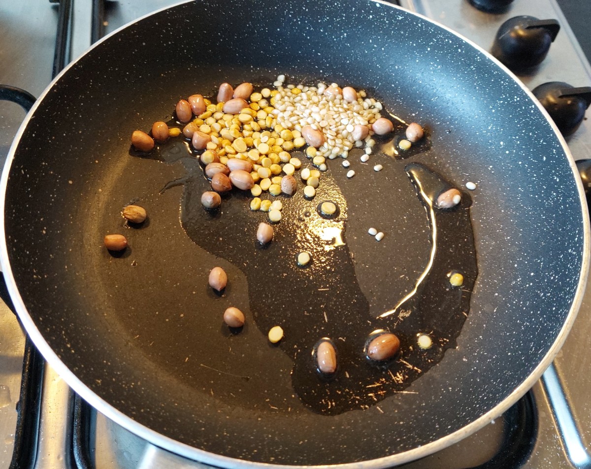 Take 1-2 tablespoon of oil in a frying pan, add 1 tablespoon of peanuts, 1 tablespoon of chana dal, 1 tablespoon of urad dal, fry till aromatic.