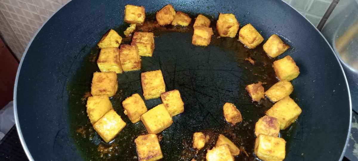 Shallow-fry the coated paneer cubes in some oil or ghee until golden brown.
