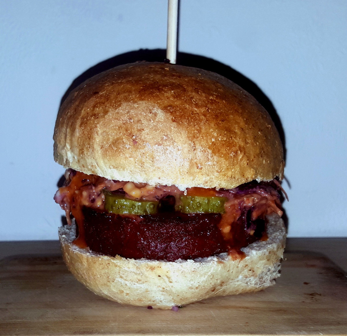 Vegan burger with gherkins  and relish in a home-baked bread roll