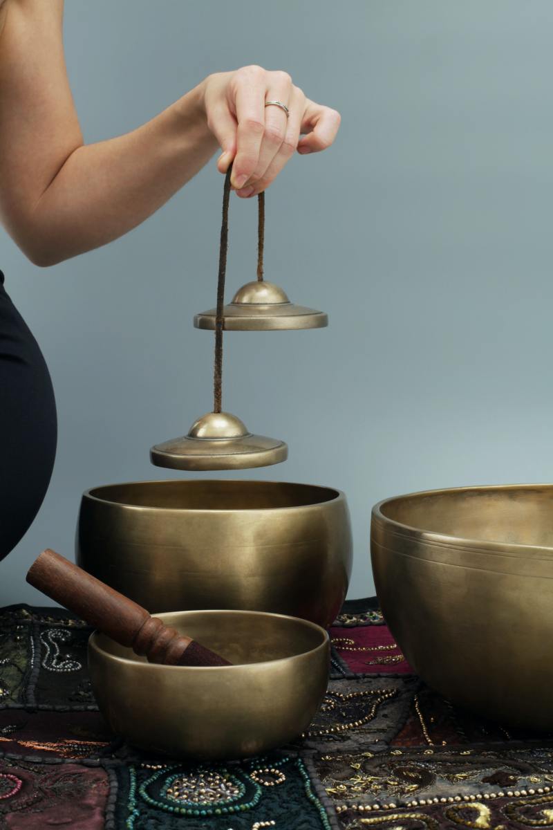 Tibetan Tingsha and singing bowls. The items are used for ancient, spiritual, and physical practices.