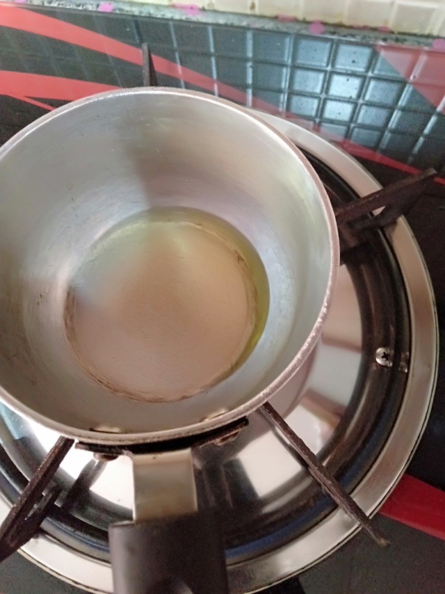 Prepare the tempering: Heat some ghee in a tempering pan.