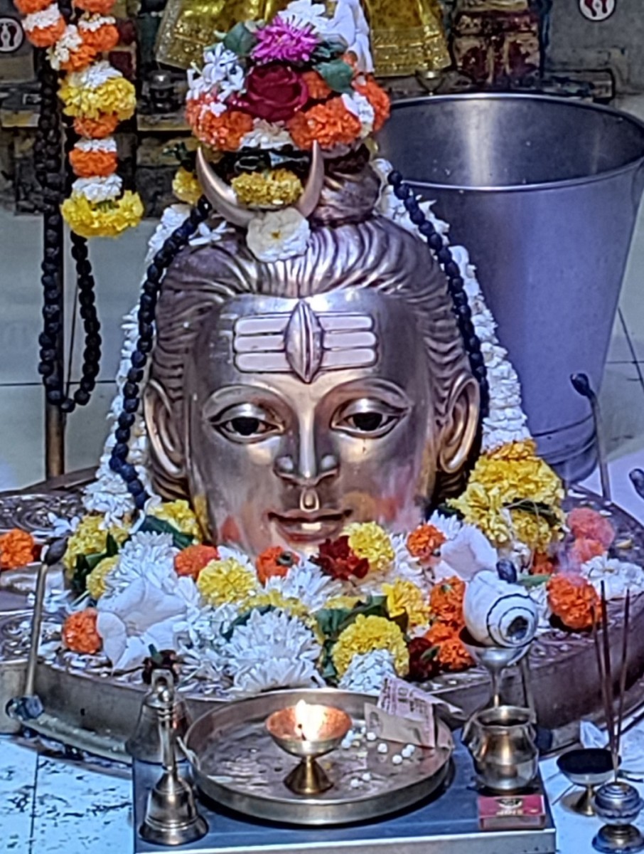 A metallic sheth with a face engraved on it covering the Shivalingam; Jagnath Shiva temple, Thane, Maharashtra