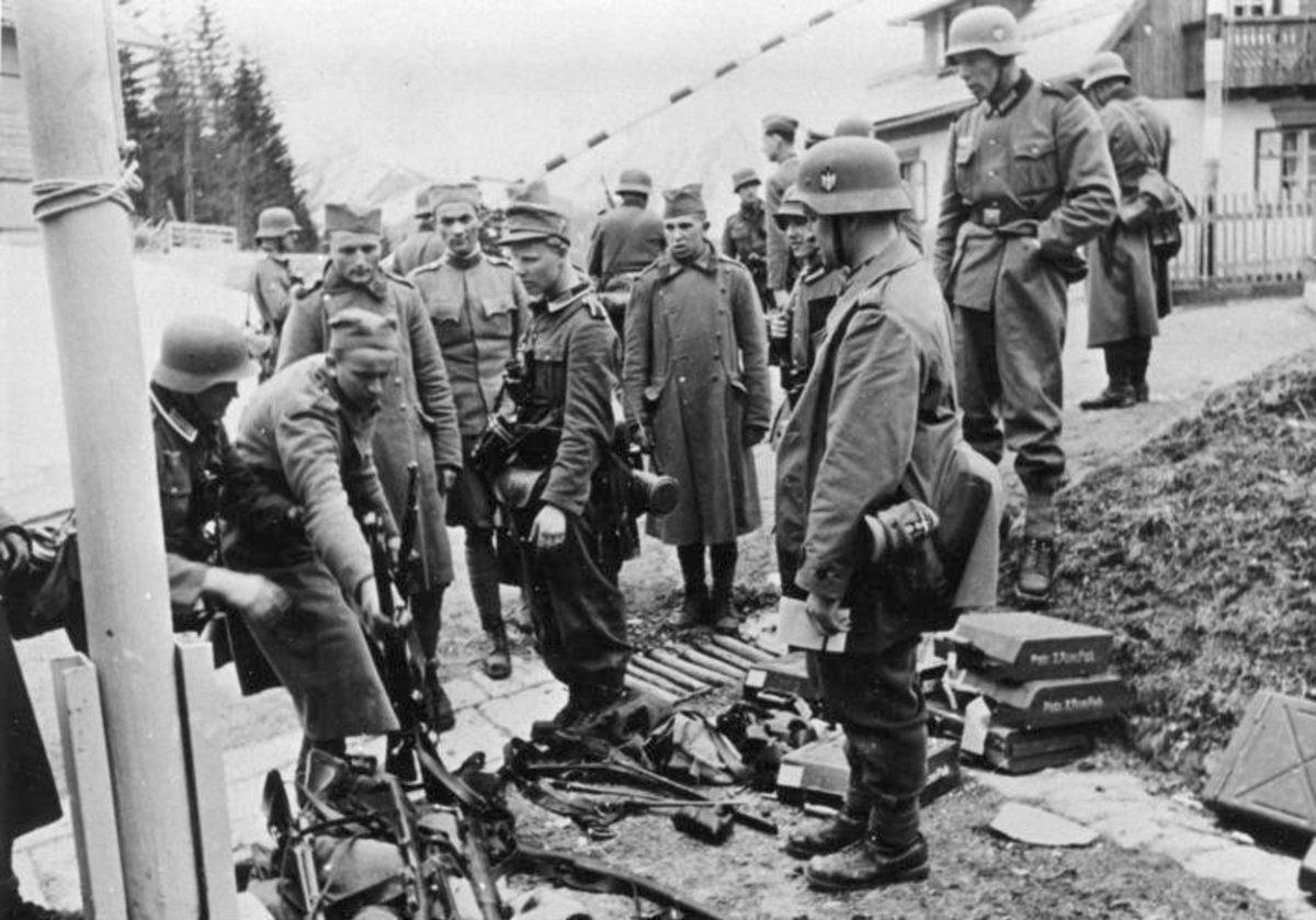 Defeated Yugoslavian soldiers surrender their weapons