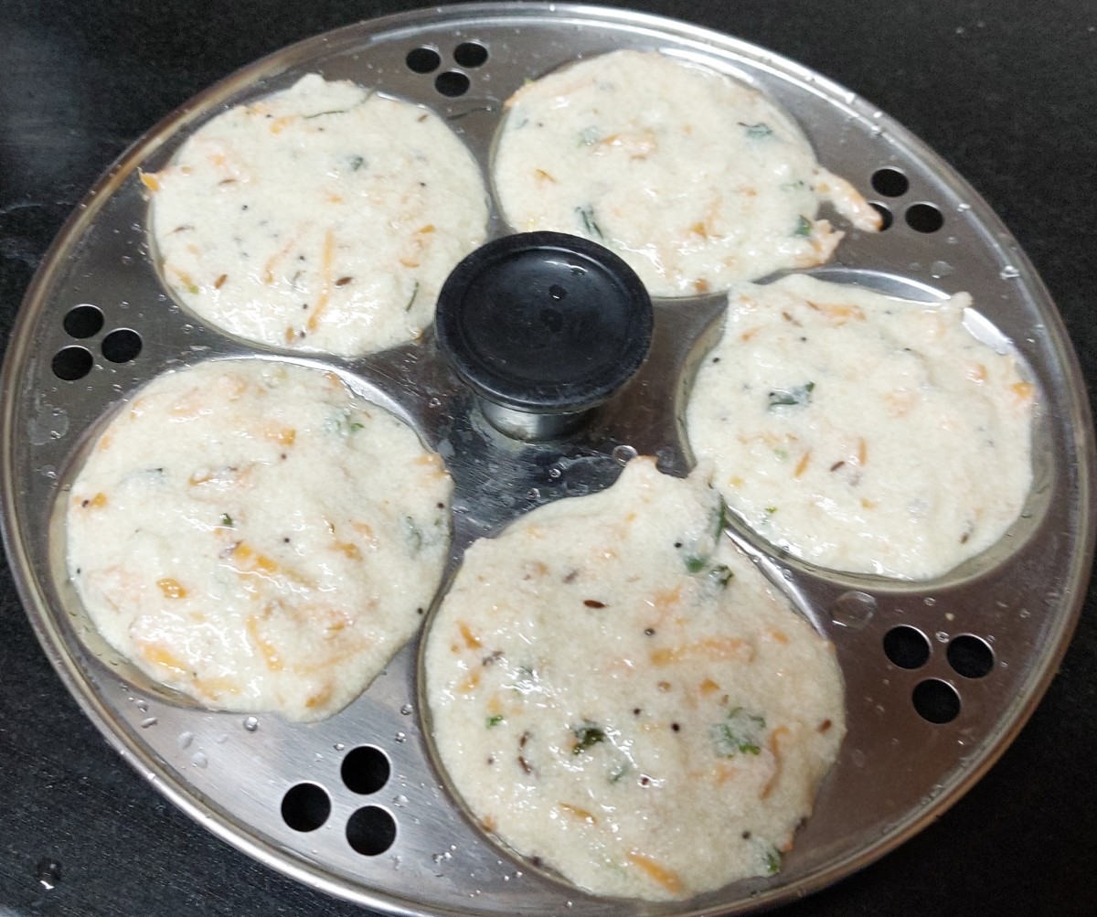 Grease the idli stand with oil and pour idli batter.