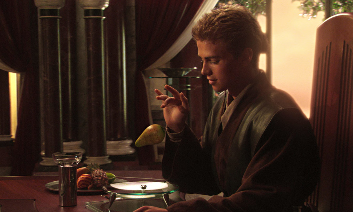 Anakin respectfully cuts Padme's food for her.