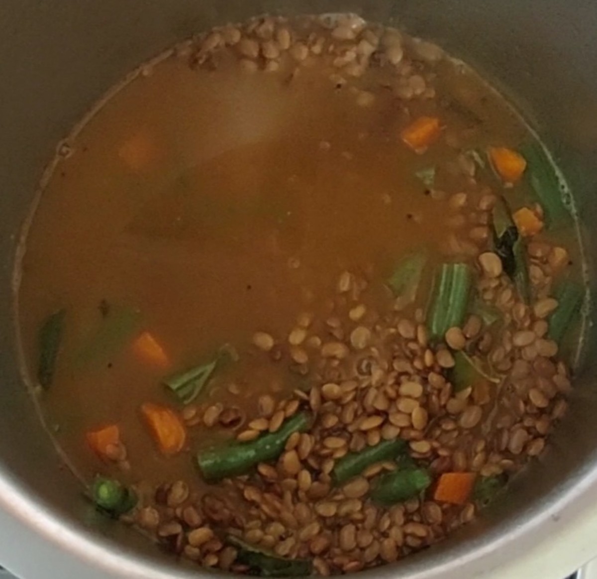 Once the vegetables are cooked, add cooked horse gram to the vegetables.