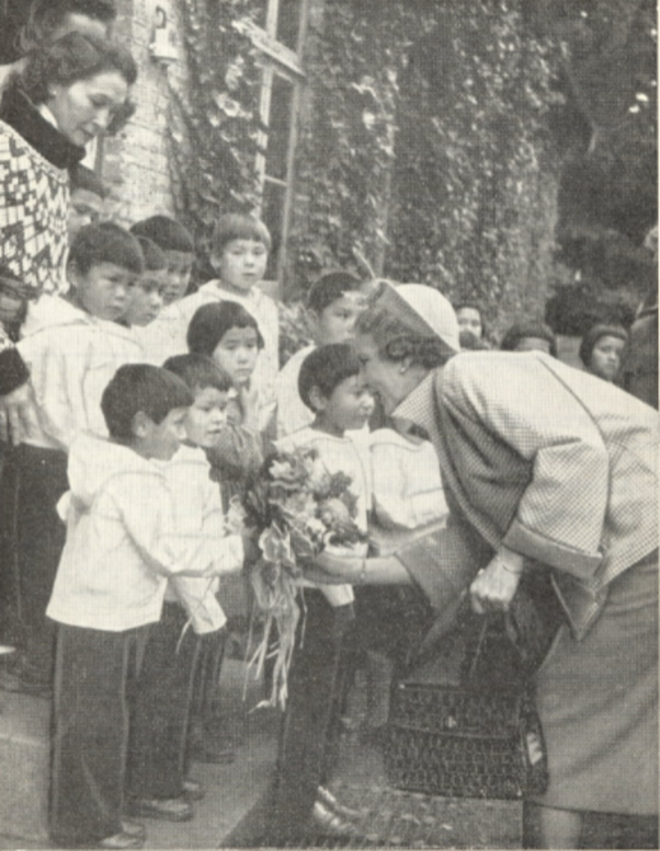 Queen Ingrid of Denmark greets the Inuit children in Copenhagen.