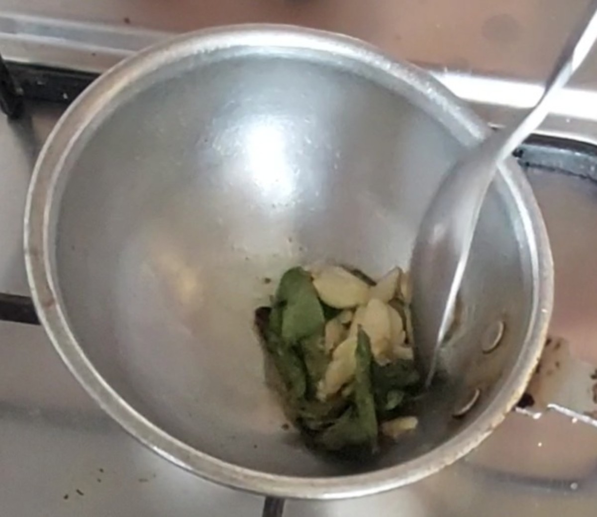 In a frying pan, heat 1 tablespoon ghee, splutter 1/2 teaspoon mustard seeds, add curry leaves, 1/4 teaspoon hing, 4-5 crushed garlic, fry till garlic turns brown and aromatic.