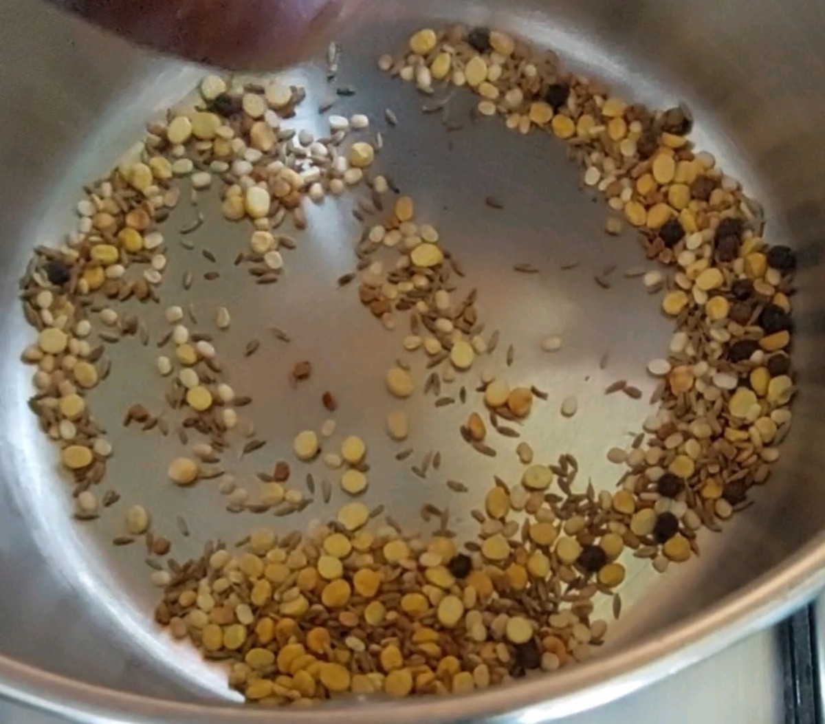 Dry-fry till the lentils turn brown and aromatic. Transfer to a plate or bowl.