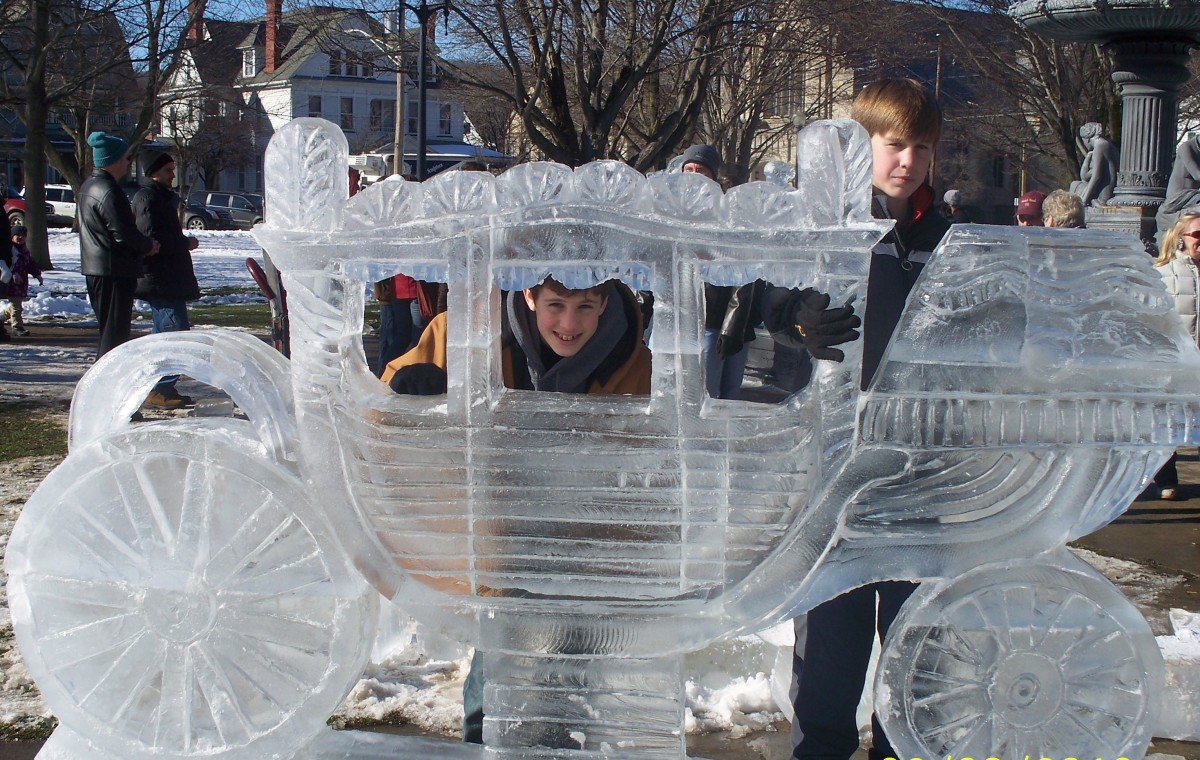 This sculpture, sponsored by Joy Manufacturing,  is in honor of Art DiMartino who founded DiMartino Ice in 1968.  Art worked for Fisher Body, a division of General Motors for 40 years. The carriage is the Fisher Body logo.