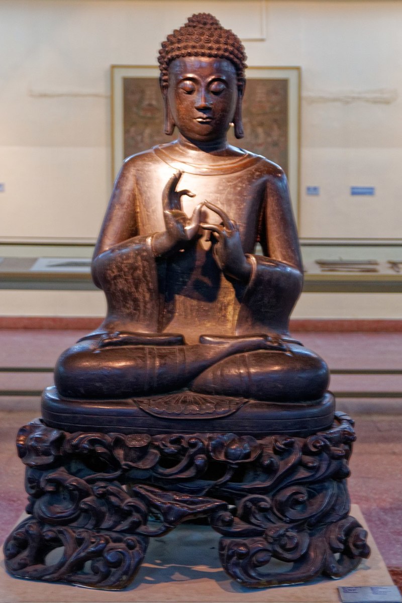 A buddha portraying the Dharmachakra Mudra hand gesture. This statue is at the National Museum in New Delhi.