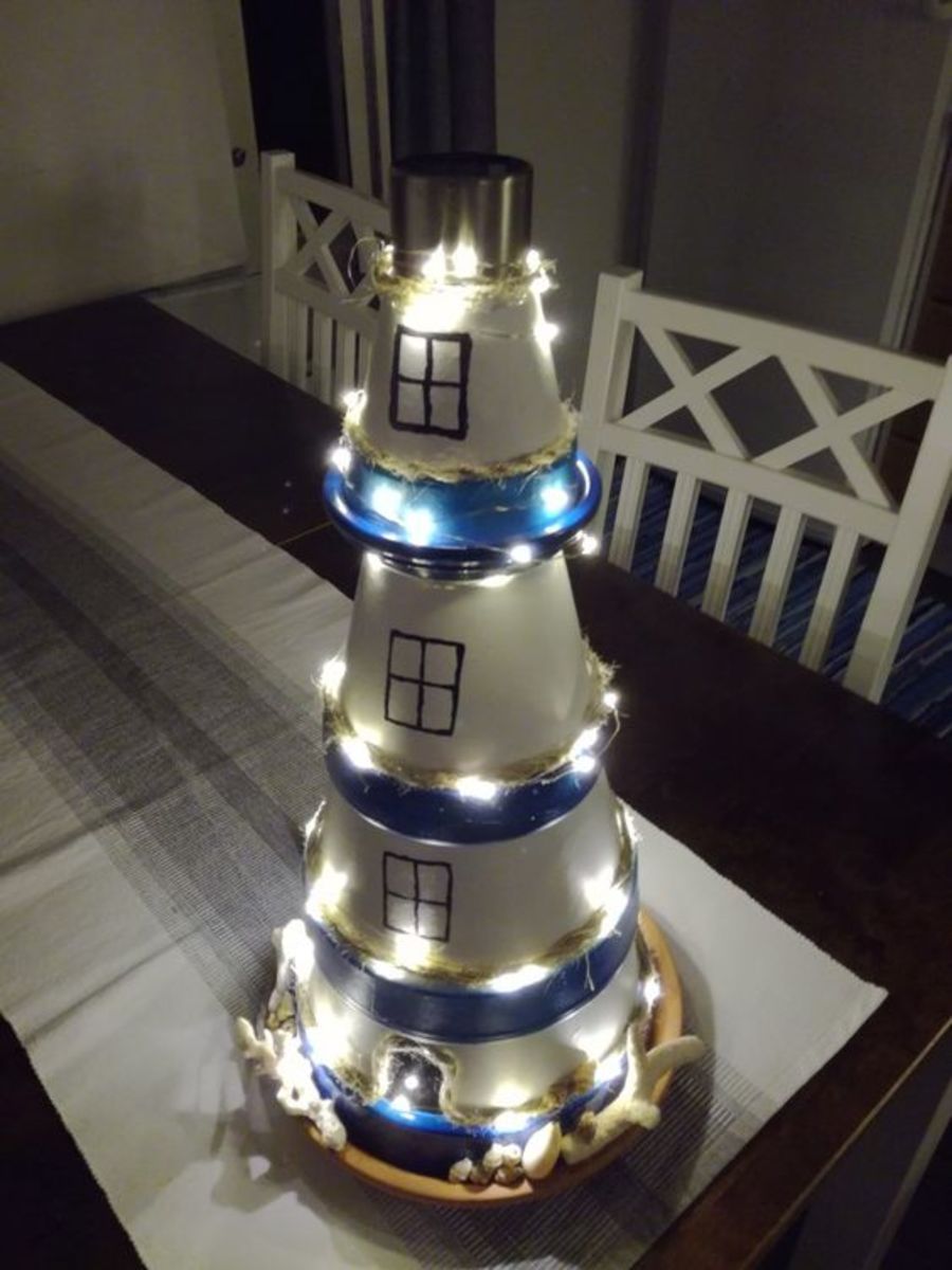 This lighthouse is made from upside-down flower pots stacked on top of each other. Don't forget the fairy lights!