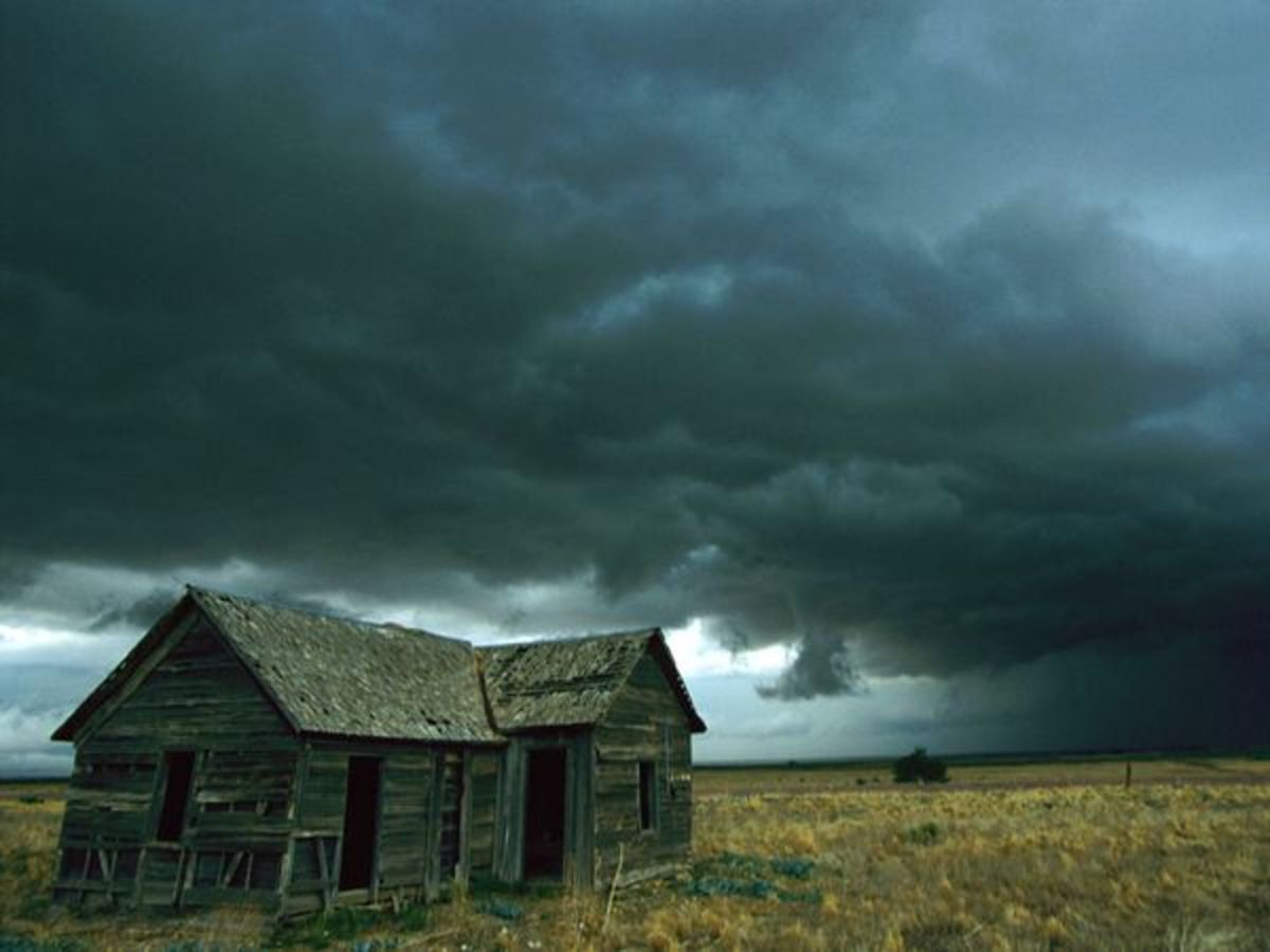 Photograph by Carsten Peter, National Geographic    Heavy clouds hang low over a dilapidated homestead in the Midwest, foretelling a possible tornado.