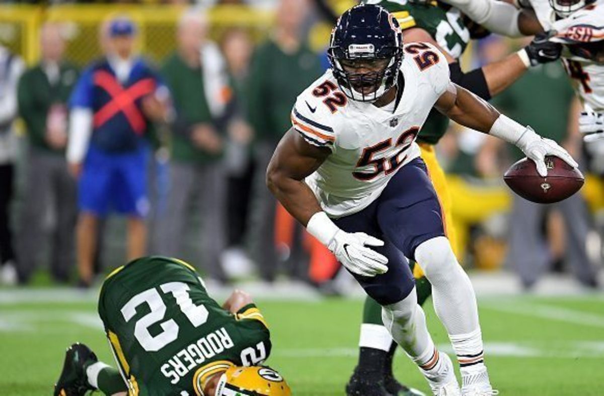 Khalil Mack takes off after stealing the ball from Aaron Rodgers.