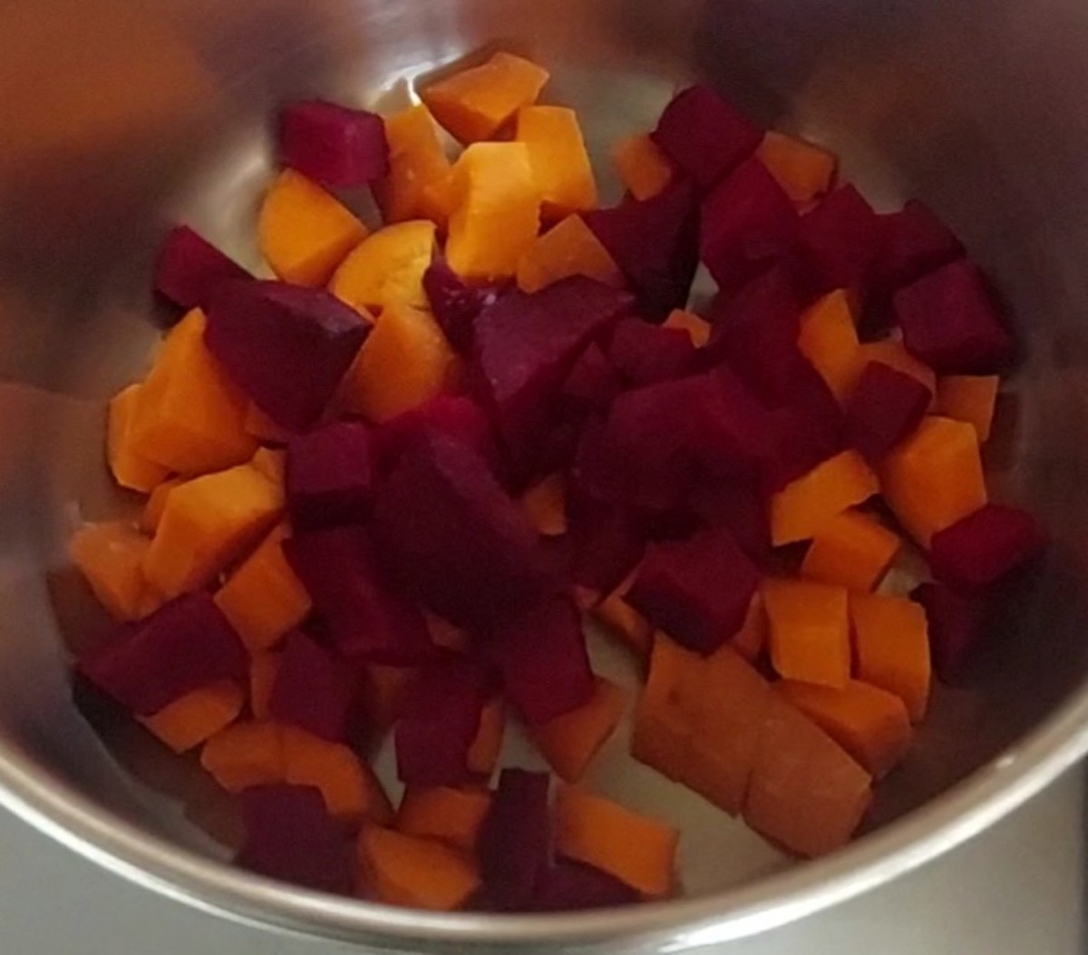 Add 1 cubed carrot and 1/2 cubed beetroot to a pot.