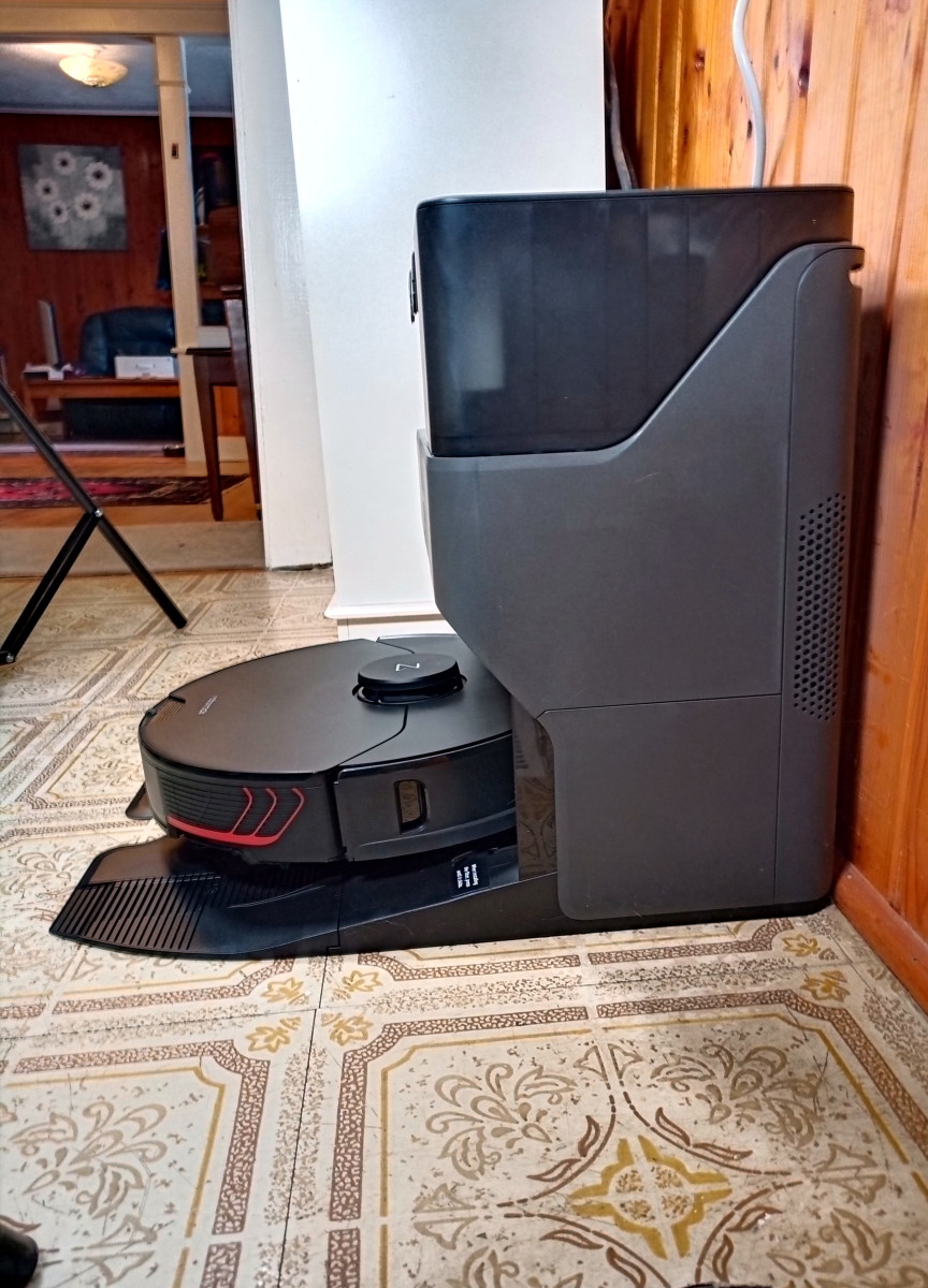 A modern Roborock robotic vacuum with a sophisticated docking system