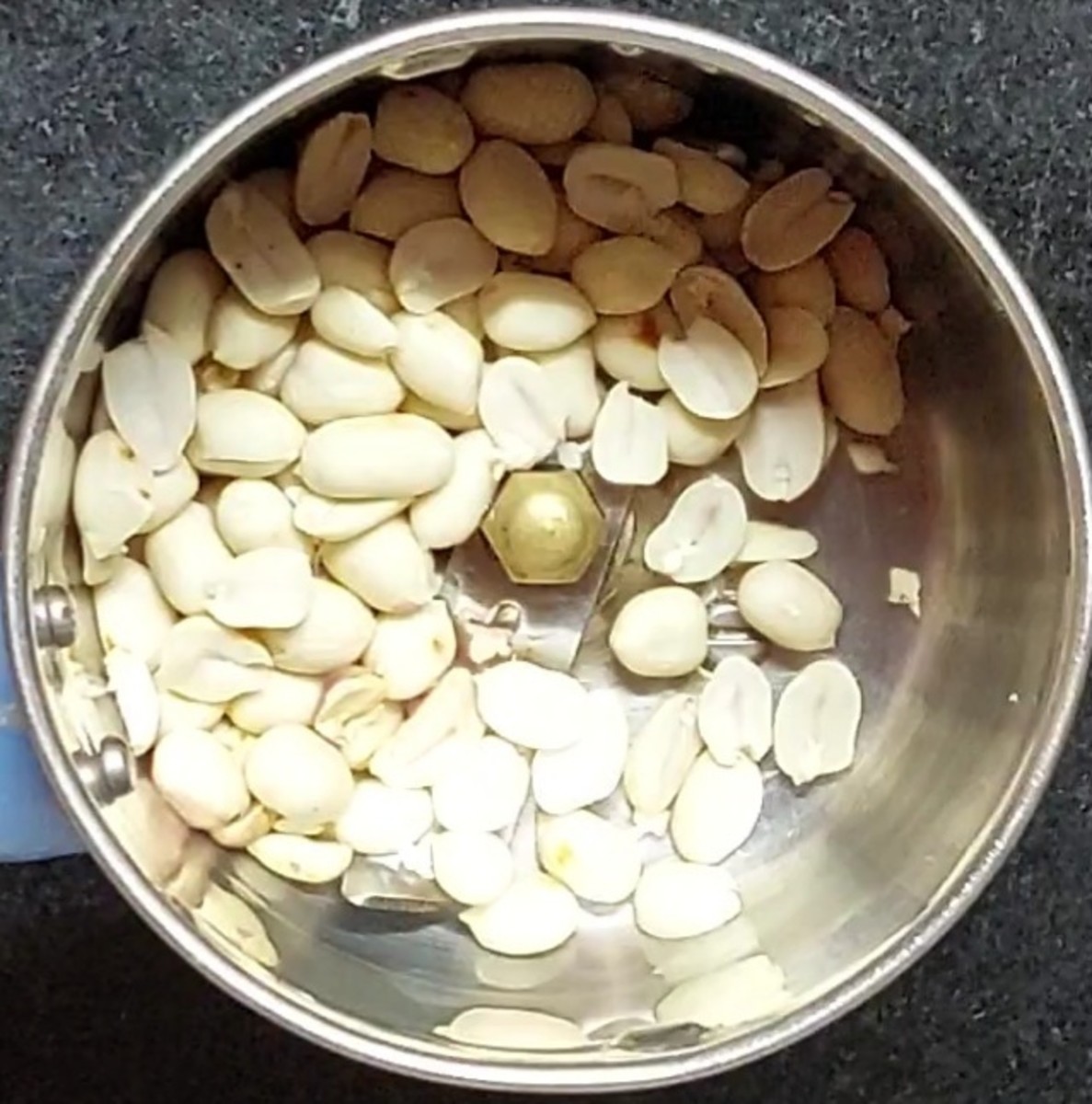 Transfer the peeled peanuts to a mixer jar.