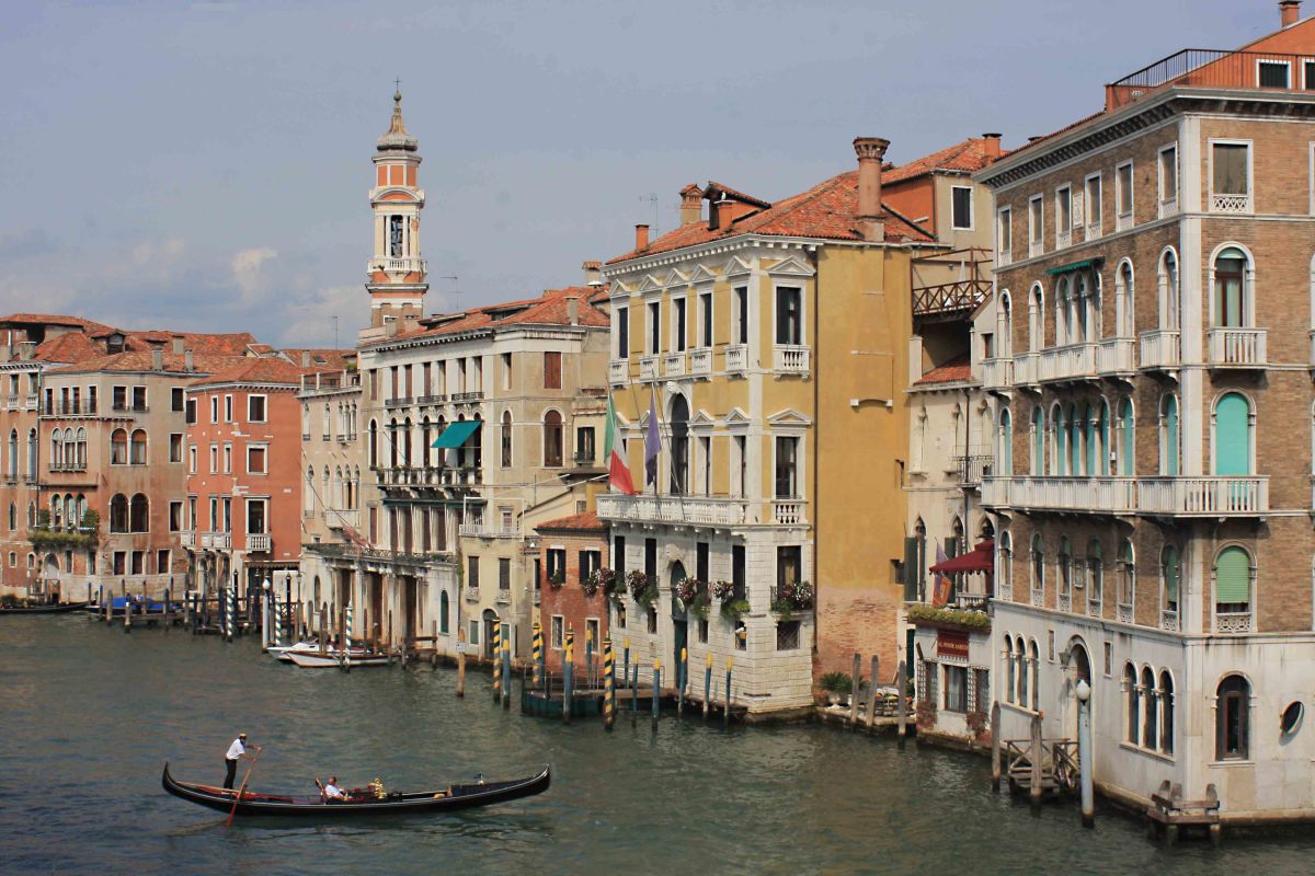 The Venice scene - A gondola gently floats past historic buildings - buildings which have seen many such scenes over many hundreds of years