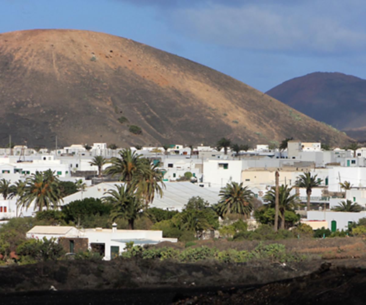 Volcanic mountains and pretty white-washed villages are characteristic sights on the Island of Lanzarote