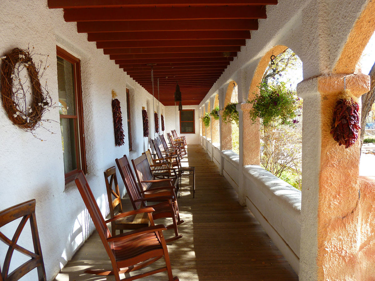 Visitors love to rock and relax on the covered porch in front of the old hotel at Ojo Caliente.
