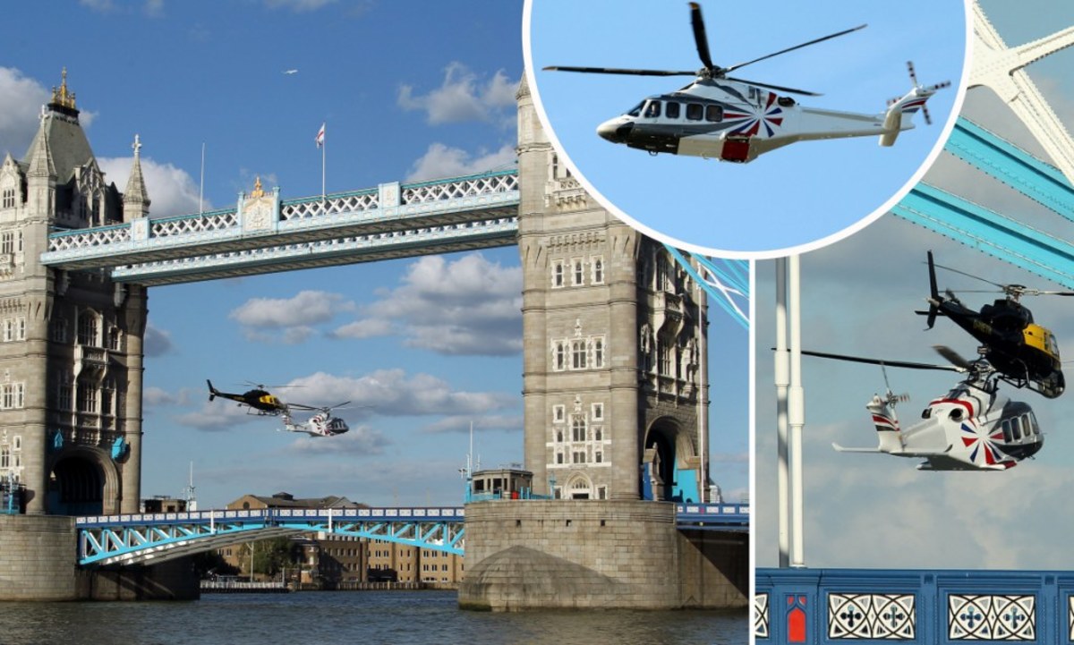 Photo showing two Queen helicopters passing through the tower bridge. 