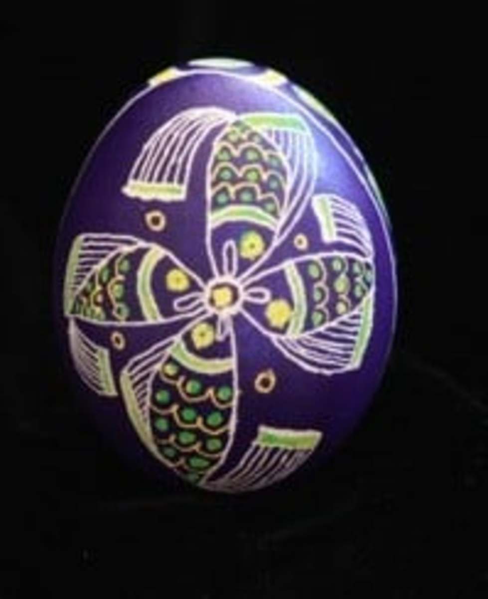 Here is an egg with a fish design. The purple color represents royalty, faith, and patience.
