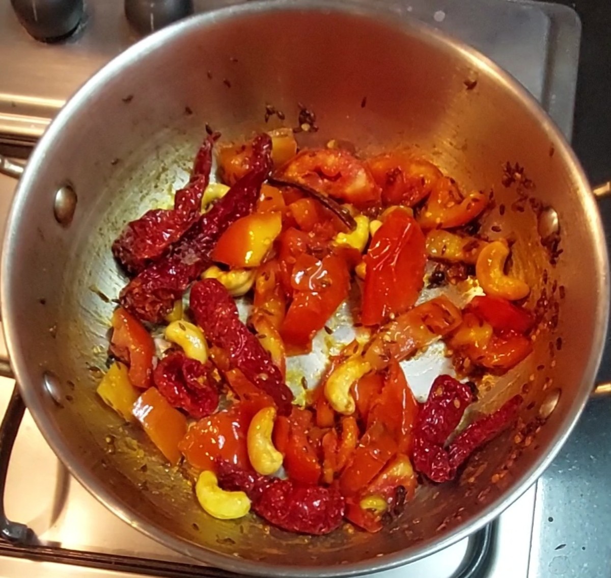 Fry for a minute, close the lid and cook over low flame till tomato shrinks and is well cooked. Add salt, mix well and switch off the flame. Let the mixture cool down completely.