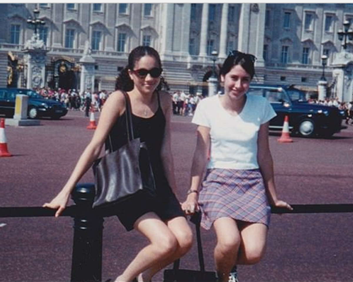 Meghan at 15 with a friend outside Buckingham Palace.