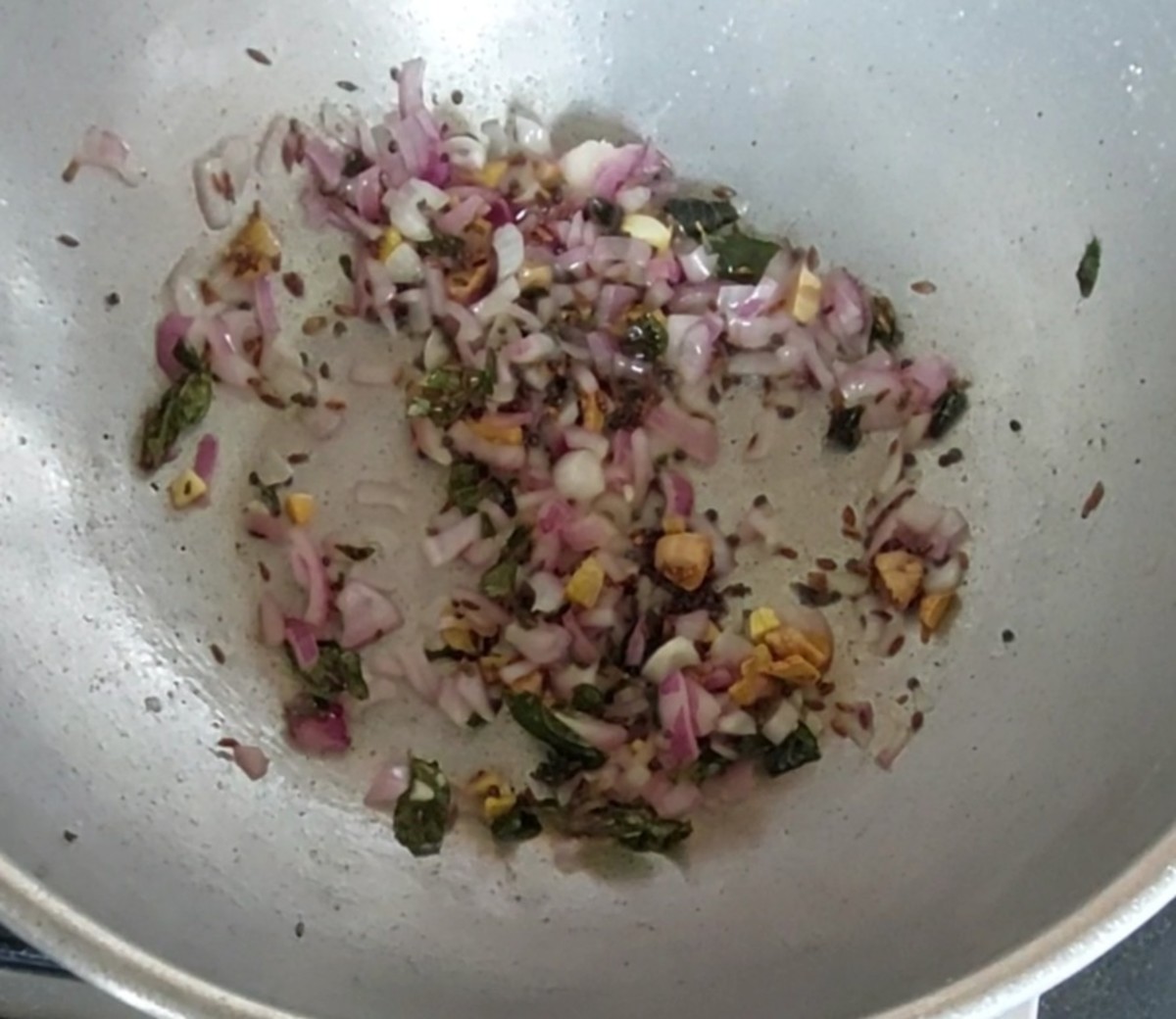 Add 1/2 cup chopped onion, saute for 1 minute, and add salt to taste. Fry the onion till it is translucent (adding salt hastens the cooking time of the onion).