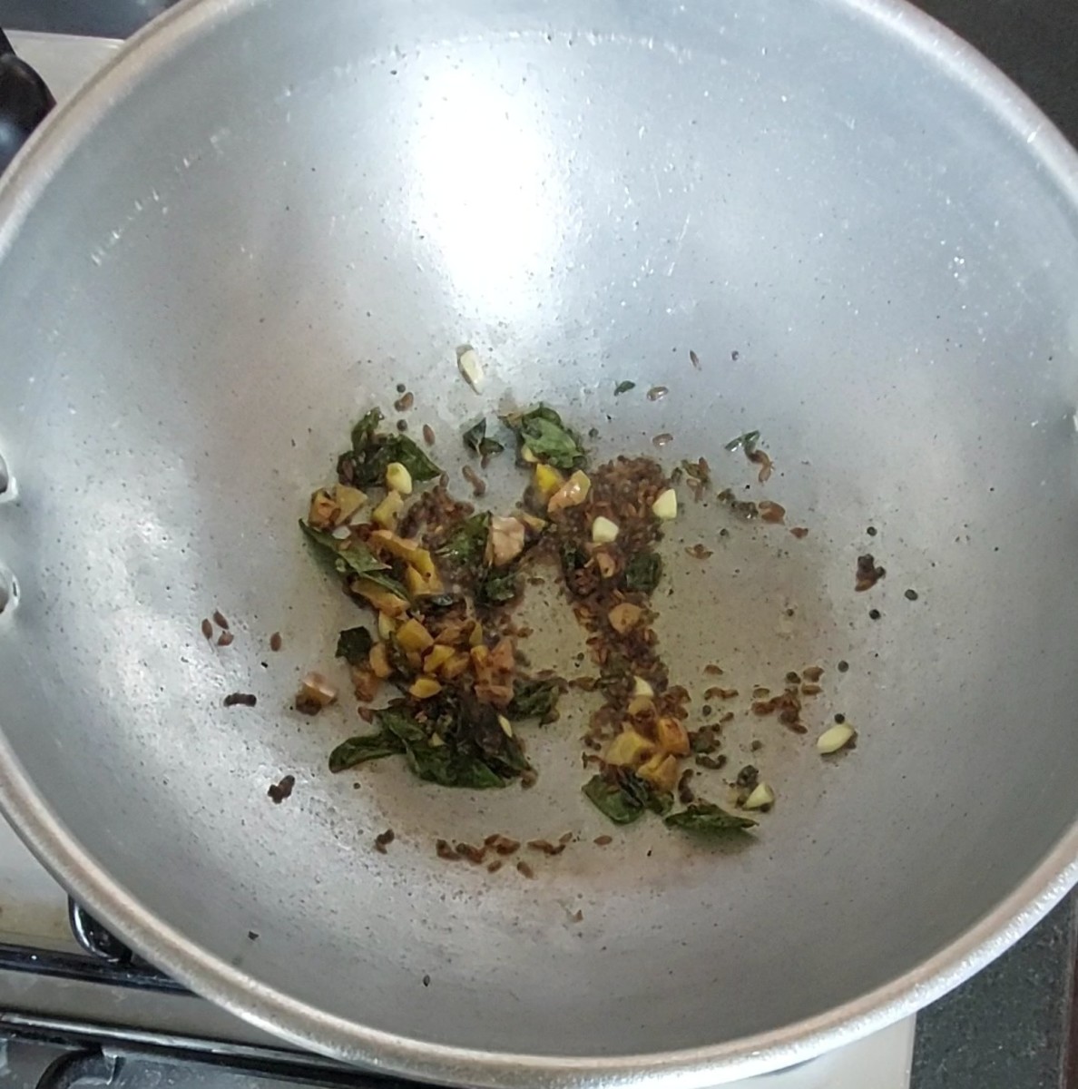 Add a chopped ginger and 3-4 chopped garlic cloves. Saute till garlic turns golden brown.