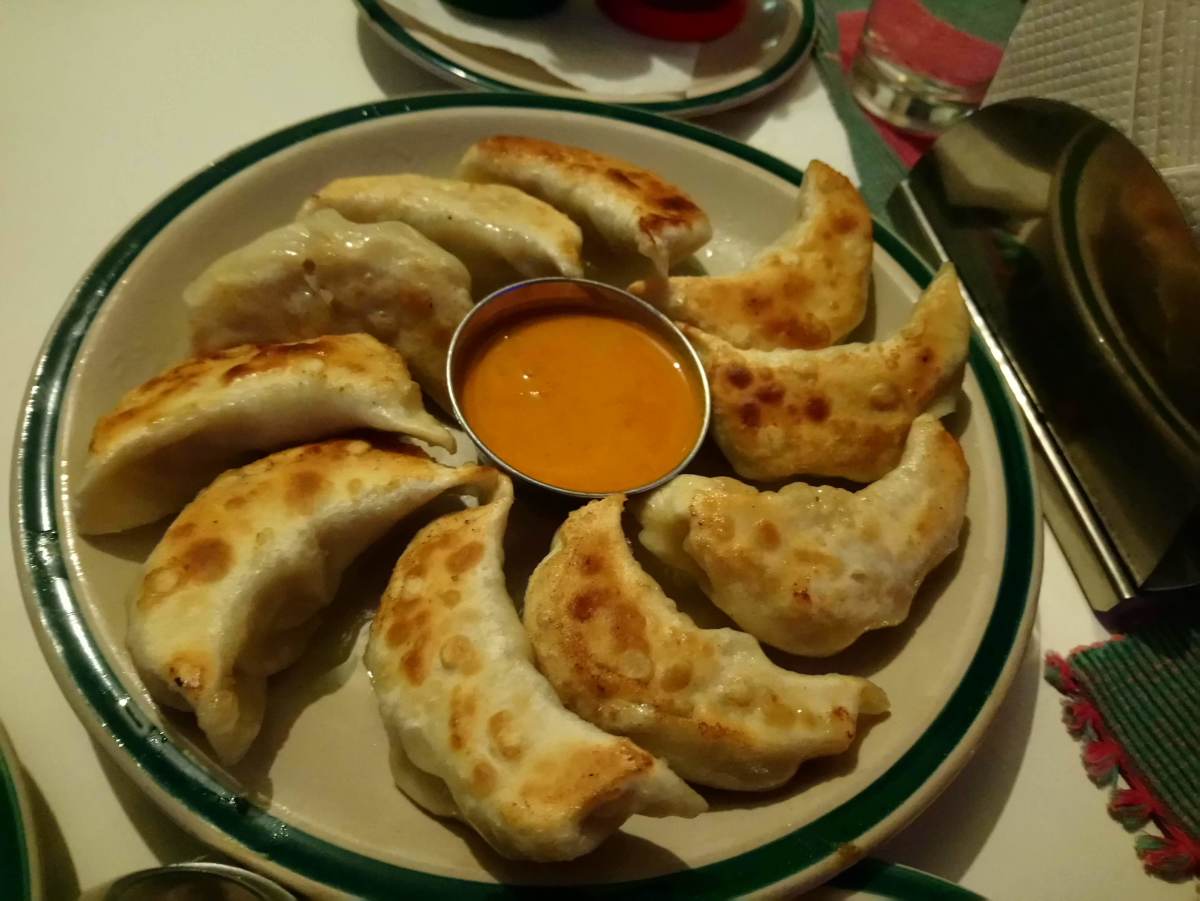 Pan-fried momos, with a special dipping sauce.
