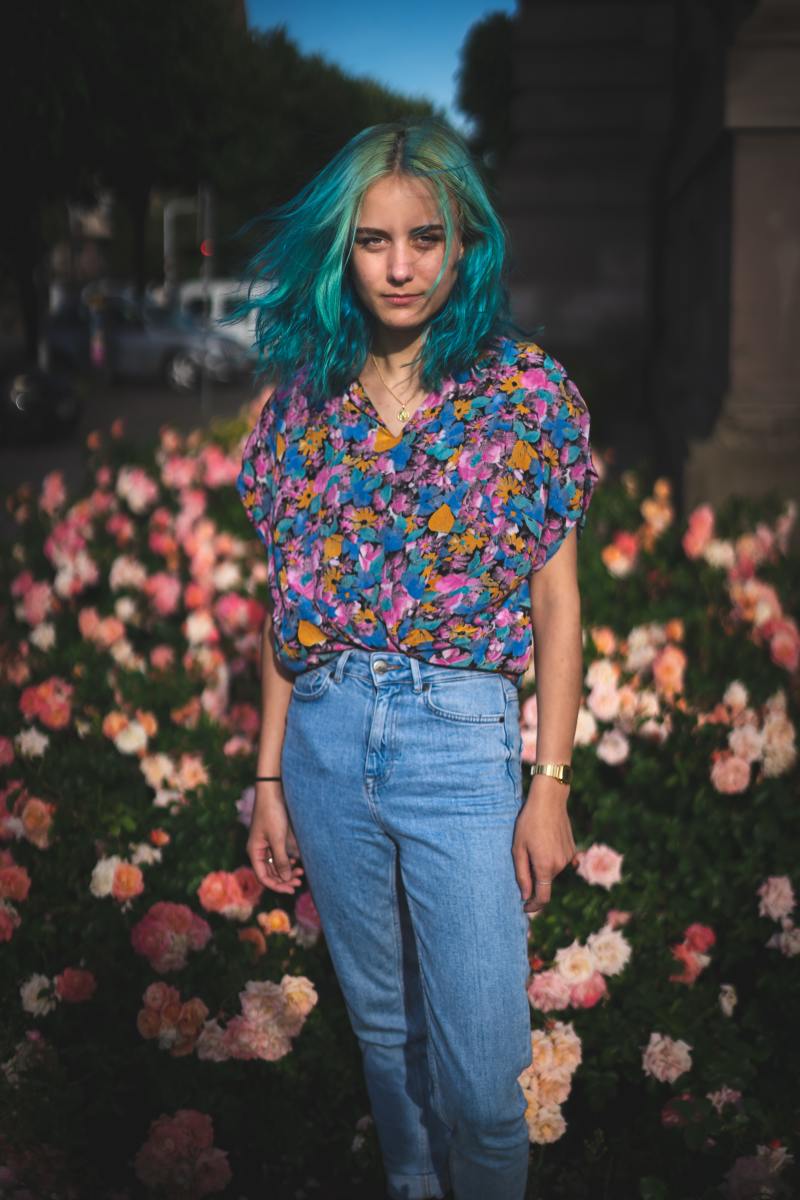 Gemini embraces fascinating hair dye colors, like teal. A floral shirt with oversaturation is also on point with Gemini's aesthetics.