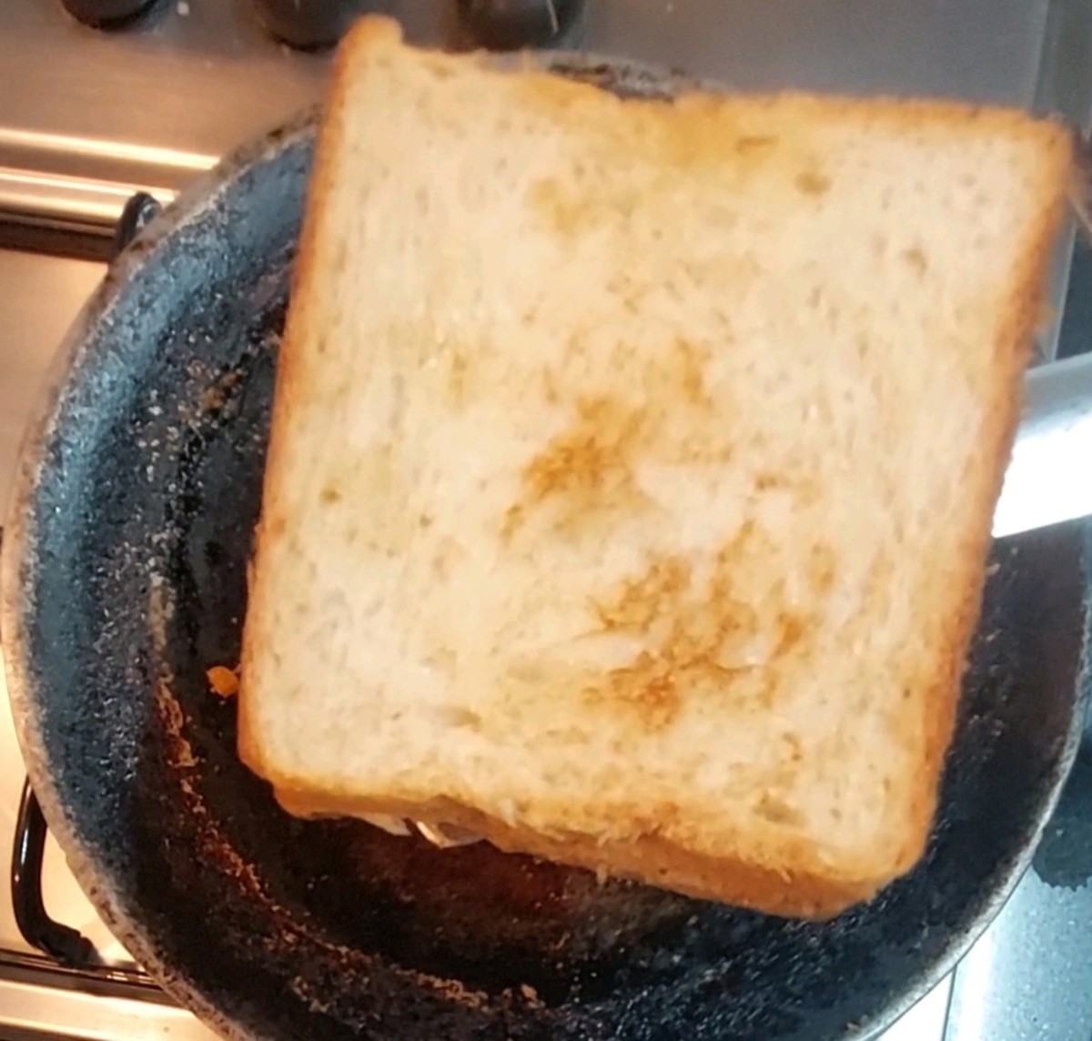 Toast over medium flame till golden brown. Sprinkle 1 teaspoon of ghee on top of the bread slice and toast on the other side, too. Take out when done.