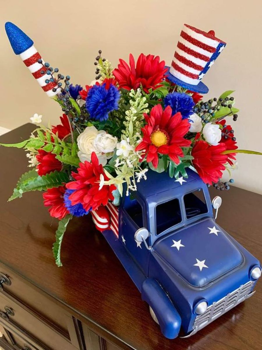 Blue truck planter with flags