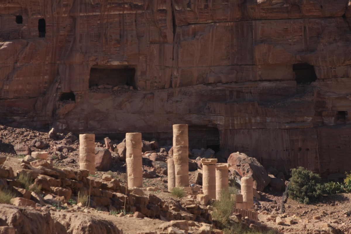 Roman pillars in front of older Nabataean tombs