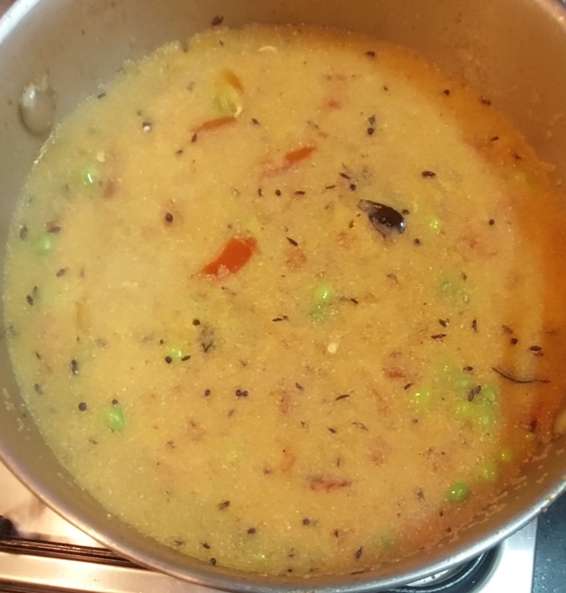 Close the lid and cook over low flame till the rava absorbs the water completely.