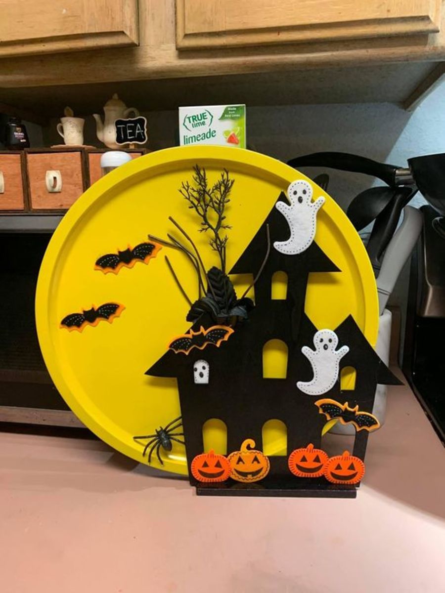 Try some easy dollar store Halloween crafts, like this spooky scene made from a pizza pan!