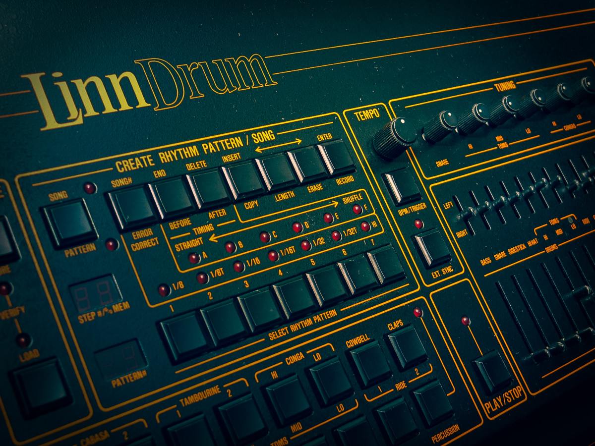 A black and green audio mixer or drum machine made in the 1980s.