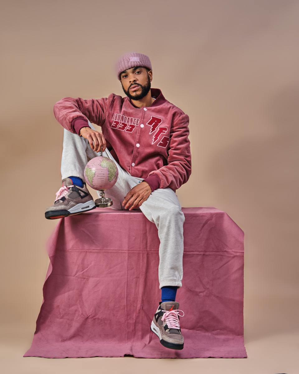 You don't have to wear pink to get the right Libra vibe, but it can definitely get you there in a pinch. This man is sporting a dark pink jacket, pink shoelaces, and a pink beanie.