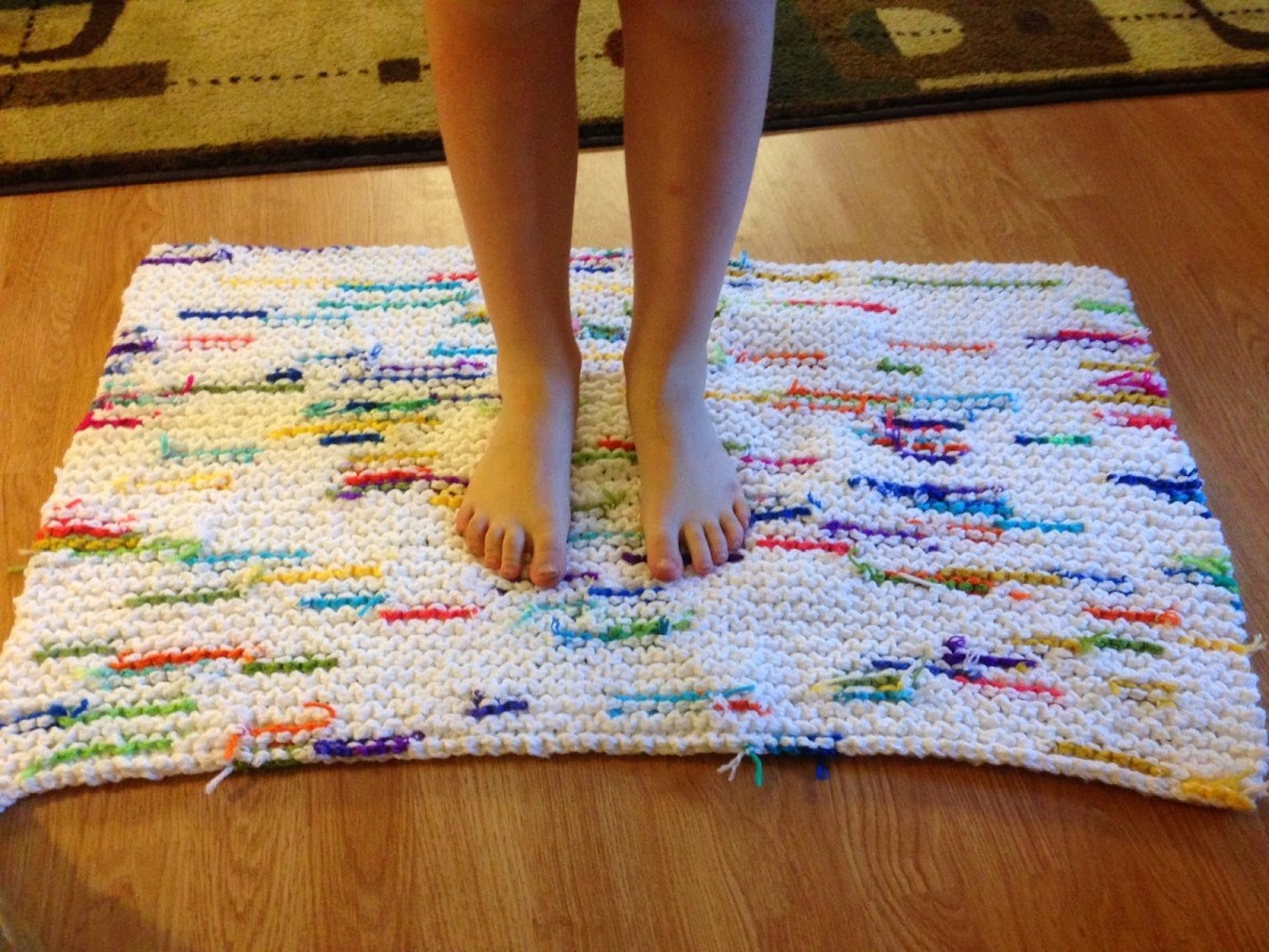 Great idea using both knitting and crochet to create a rug made of left over yarn
