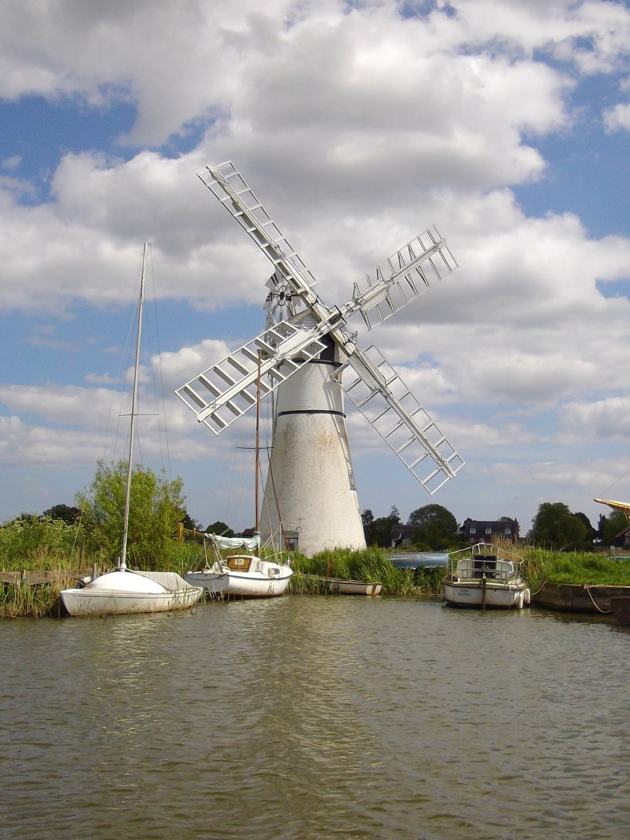 Windmill by the side of the lake on the Norfolk Broads.
