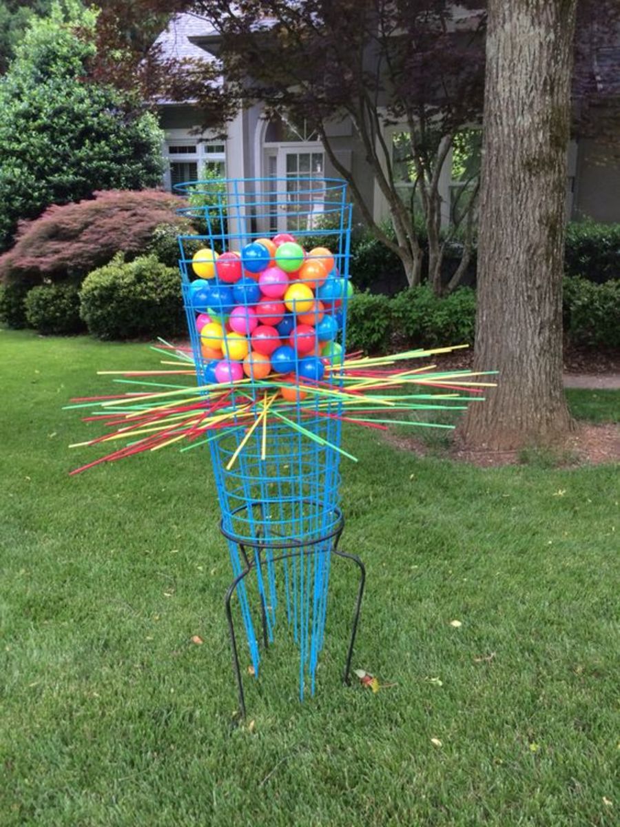 Giant Kerplunk game! Purchase six blue tomato cages and turn them upside down in a 20'' high plant stand. Paint 3' bamboo skewers, but you could also use bamboo tomato stakes.