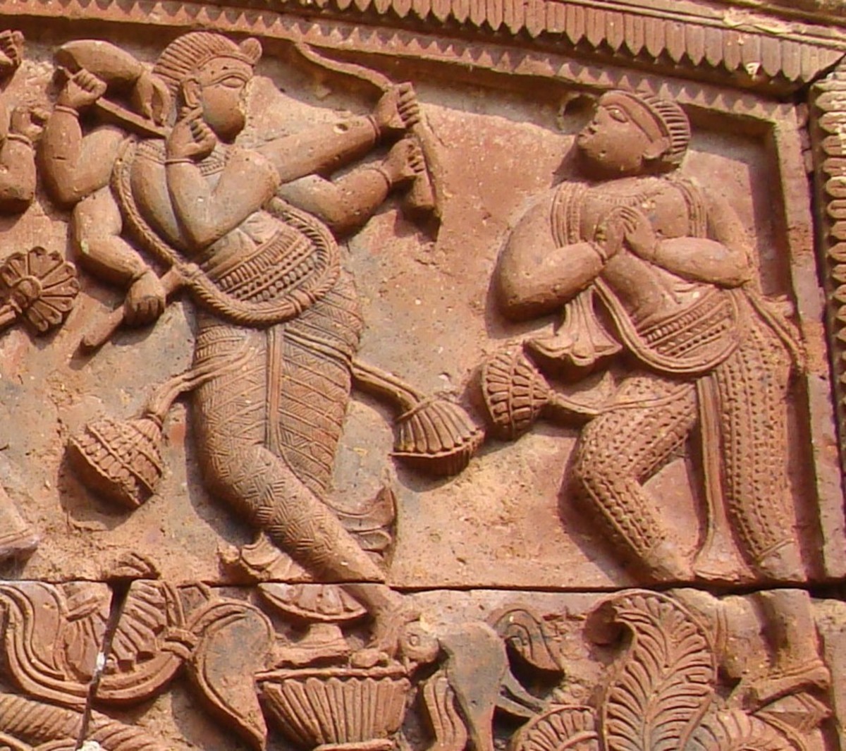 Shadbhuja Gauranga in stone work, Shiva temple, Ganpur. There is a single person accompanying Shadbbhuja Gauranga.