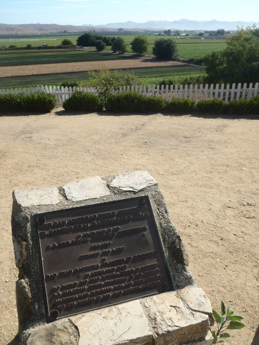The San Andreas fault plaque at Mission San Juan Bautista. The fault is located at the base of the slope, below the white fence.