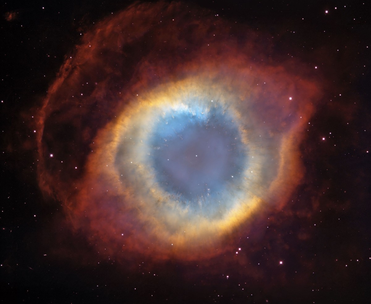 A planetary nebula (the Helix Nebula) expelled by a dying star.